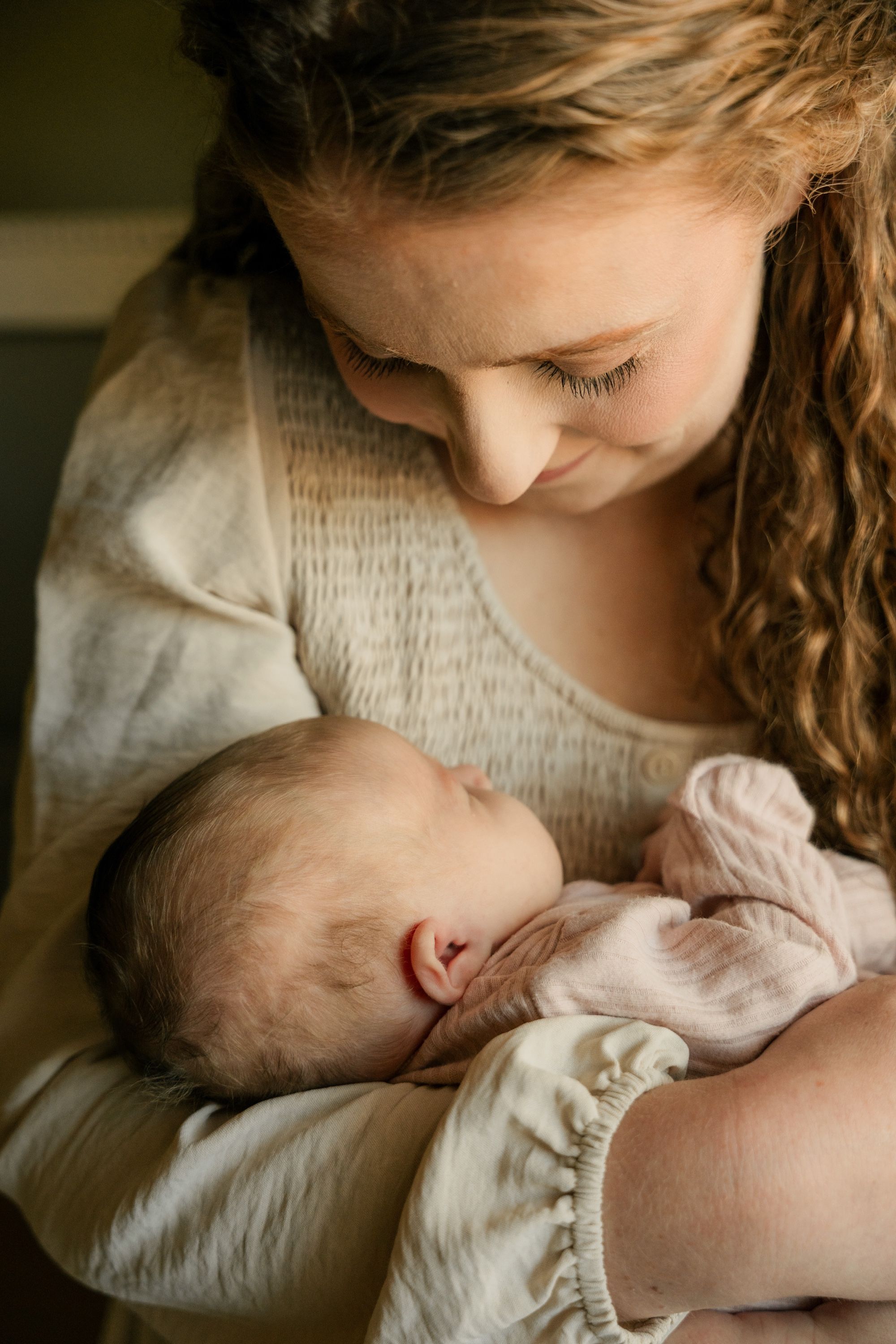 Mother looking down at her newborn, Memphis family photography by Atkinson Studio