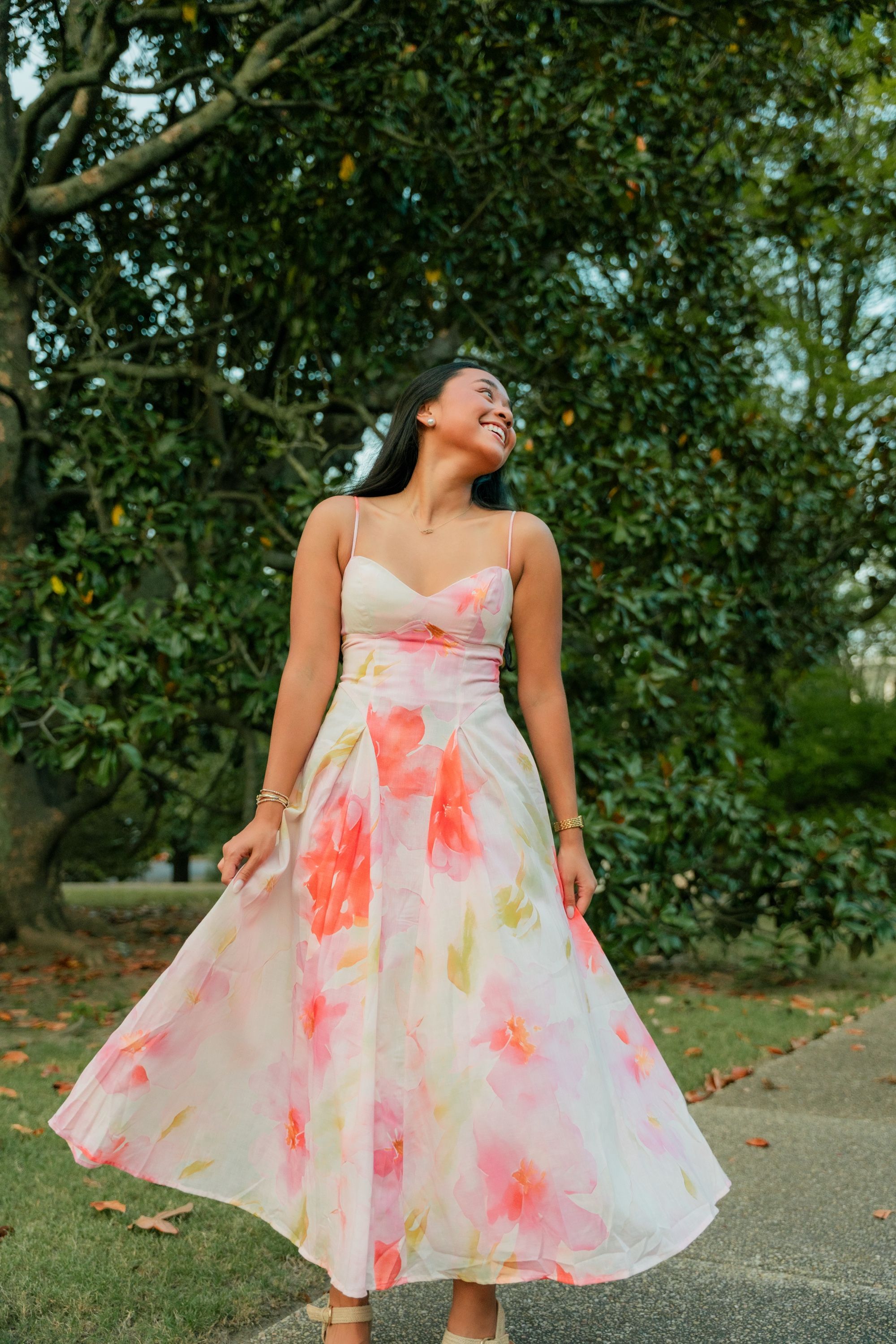 Senior twirling her gown beneath a magnolia, Memphis senior portraits by Atkinson Studio