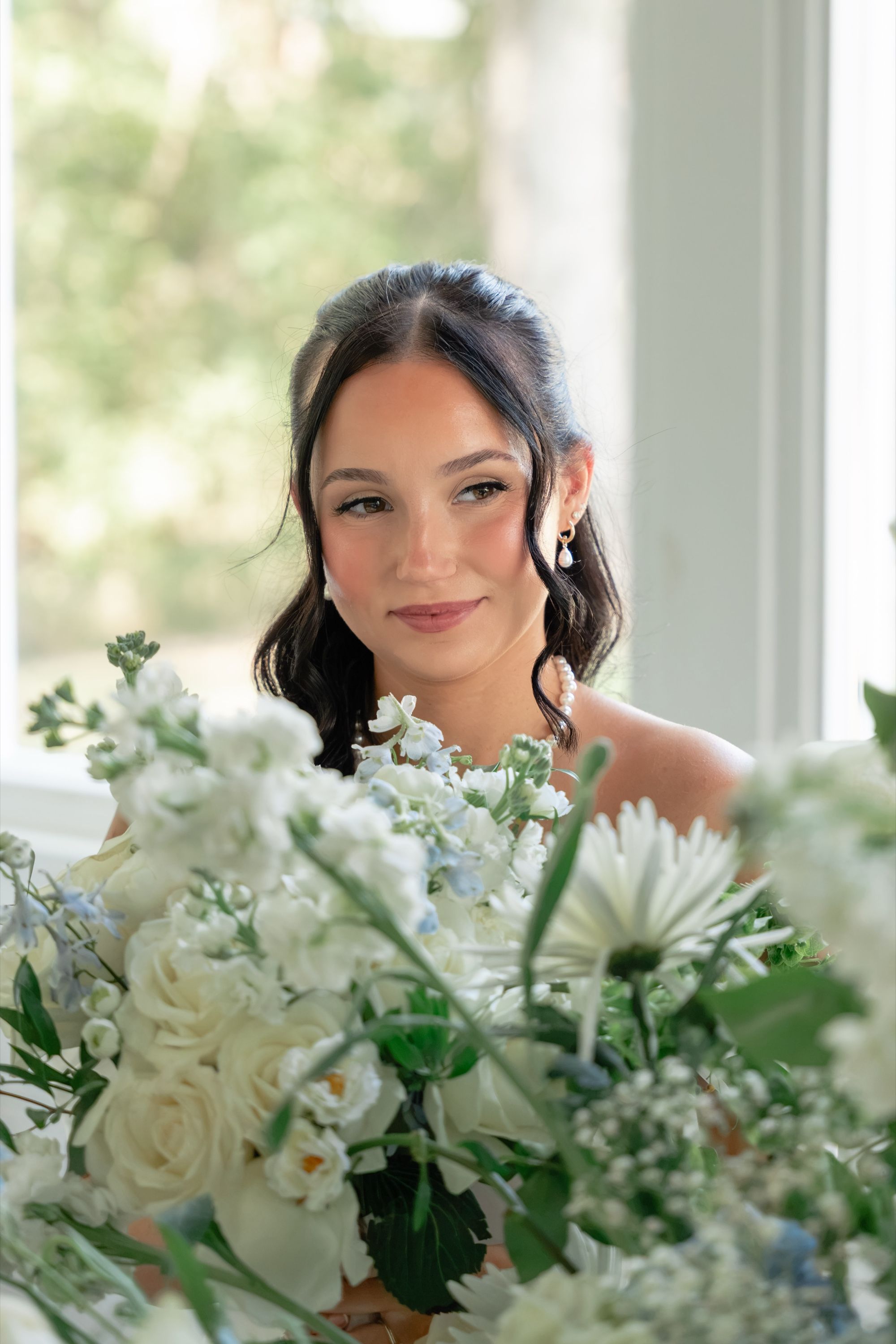 Bride smiling behind her white and blue bouquet, Memphis wedding photography by Atkinson Studio