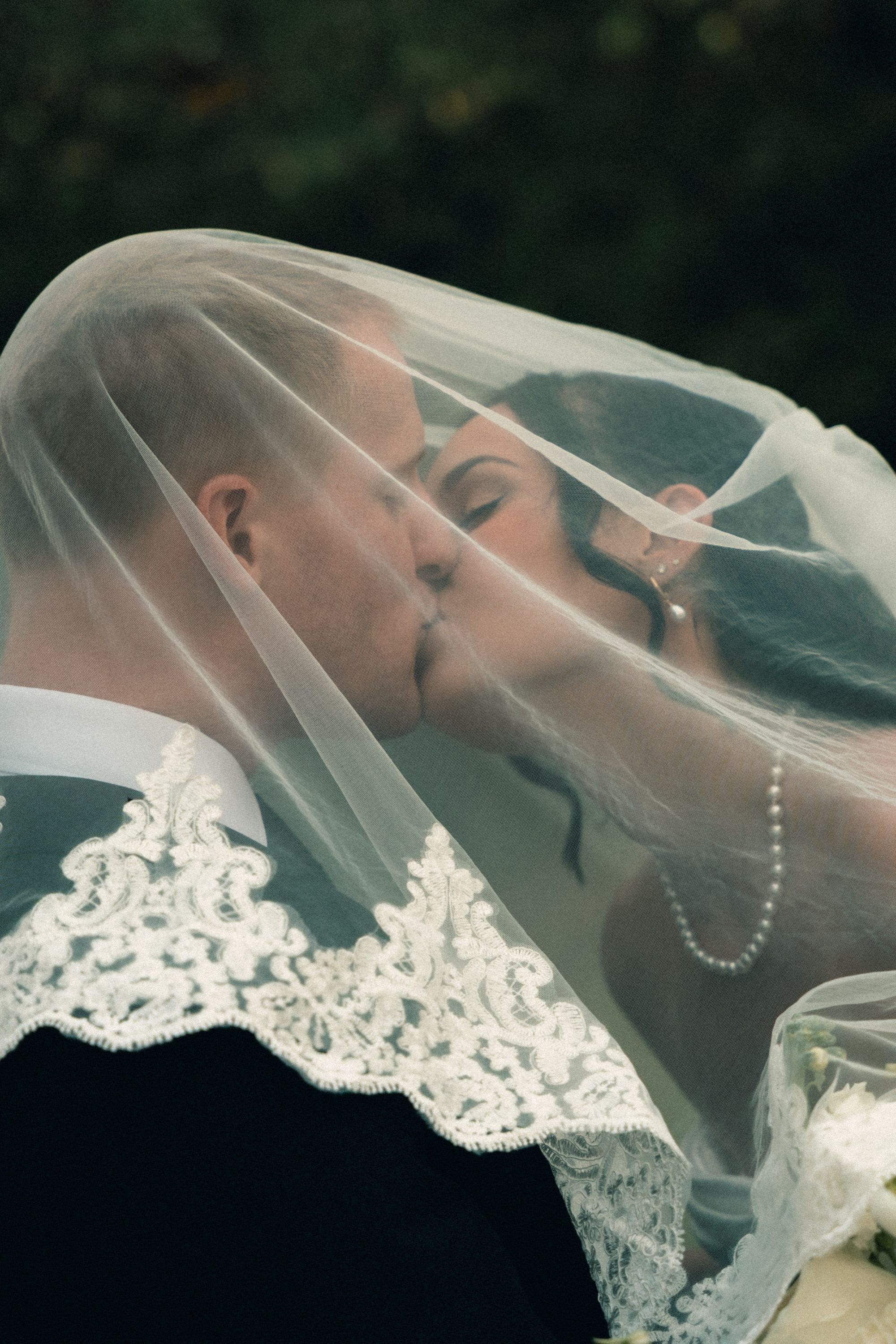 A kiss under the veil at a Salt Chapel wedding, Memphis wedding photography by Atkinson Studio