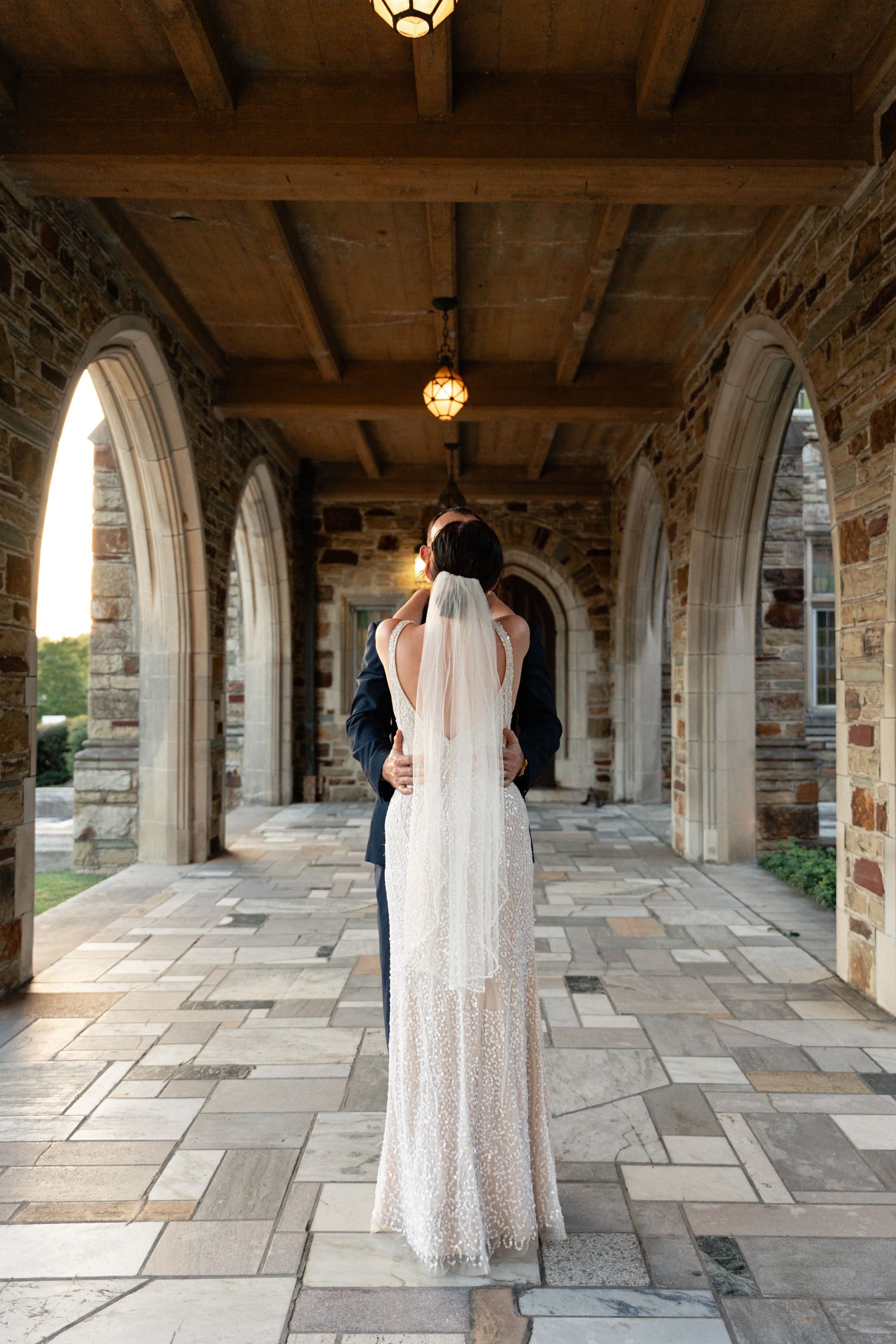 Bride and groom walking through the cloister at Idlewild in Midtown Memphis, Memphis wedding photography by Atkinson Studio
