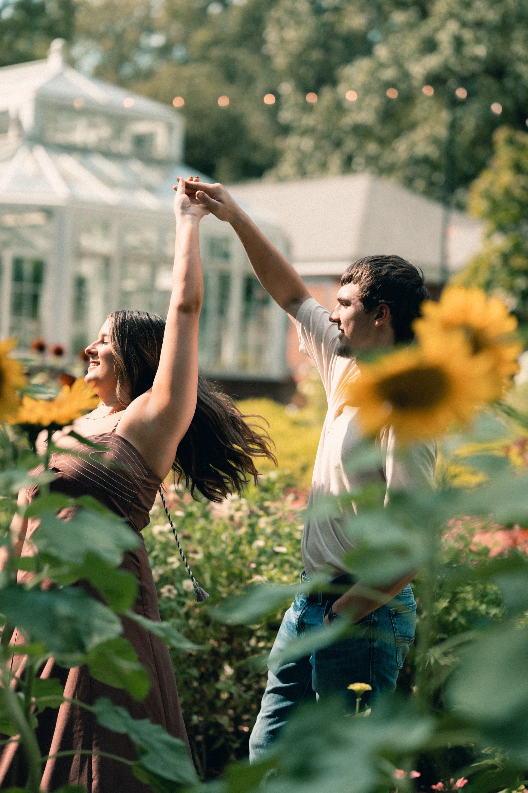 Engagement session twirl among sunflowers