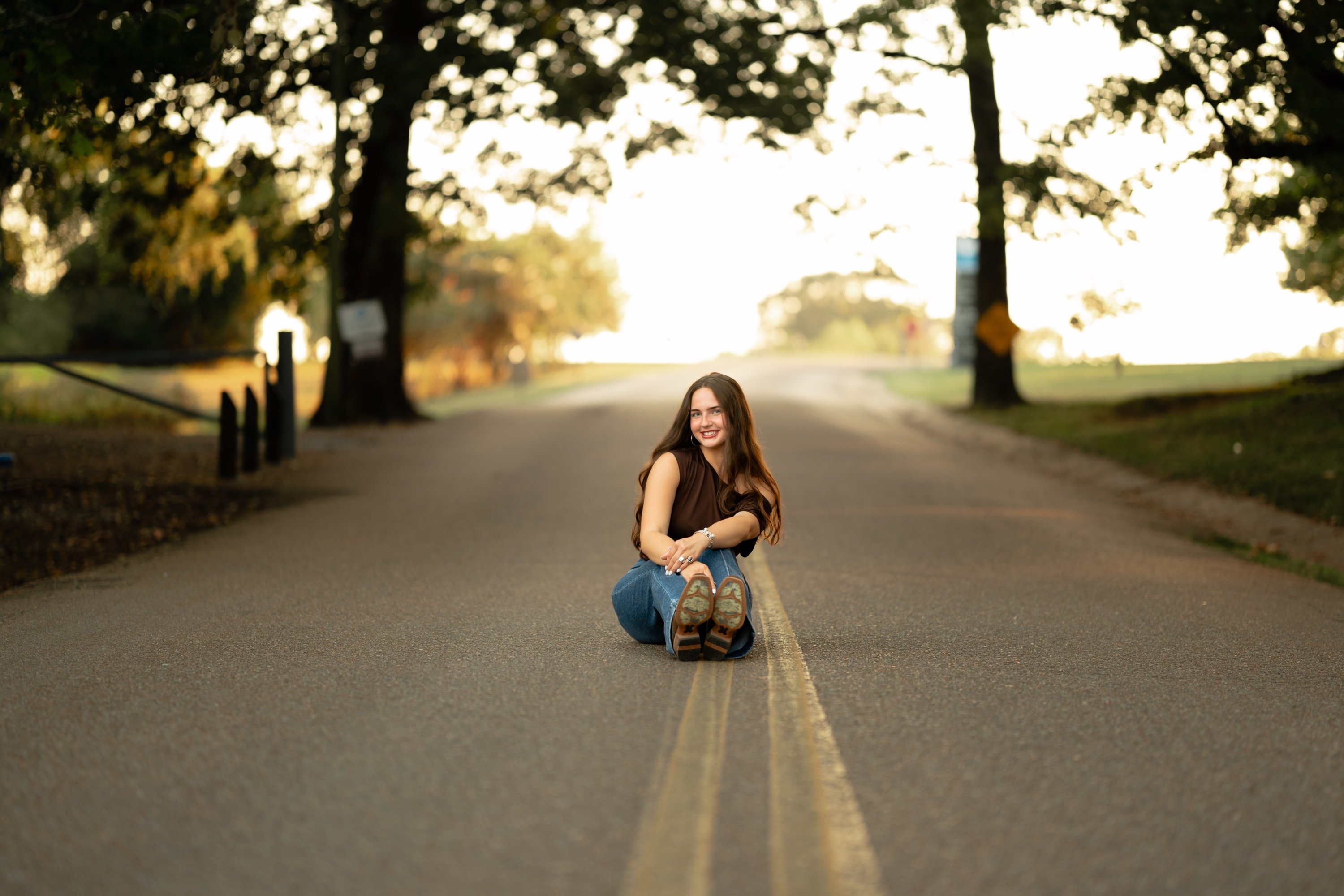 Senior portrait on a tree-lined country road at sunset, Memphis senior photographer